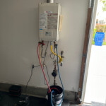 Tankless water heater being descaled. - Plumbing